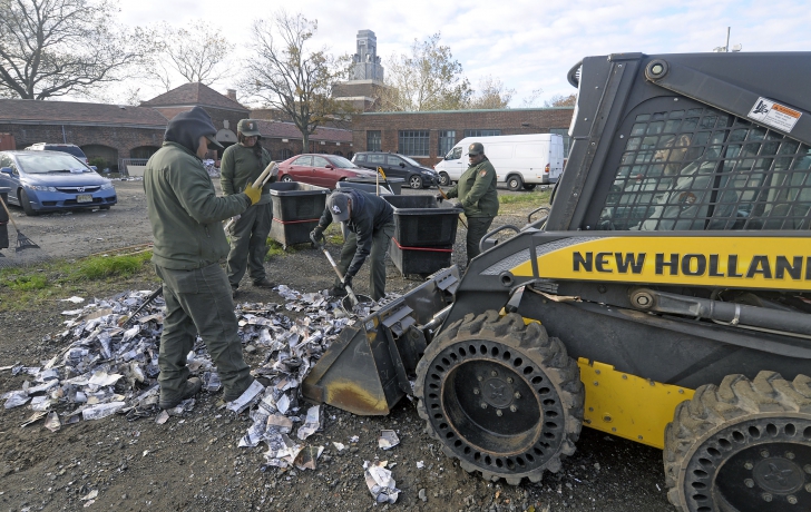 Grounds crew members cleaning up the mess. Grounds crew members cleaning up the mess.